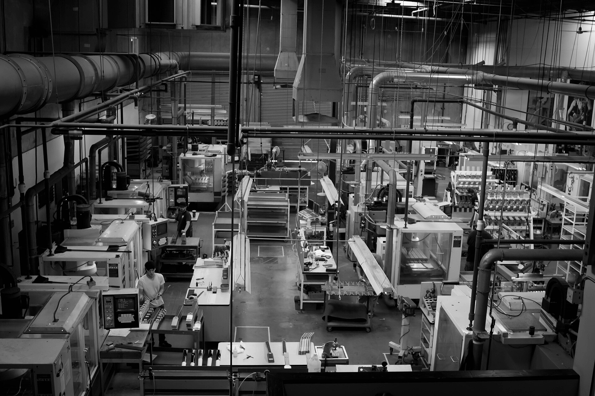 Row of CNC milling machines on a production floor